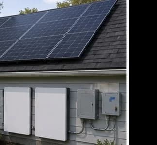 Homeowner reviewing battery backup loads with electrician